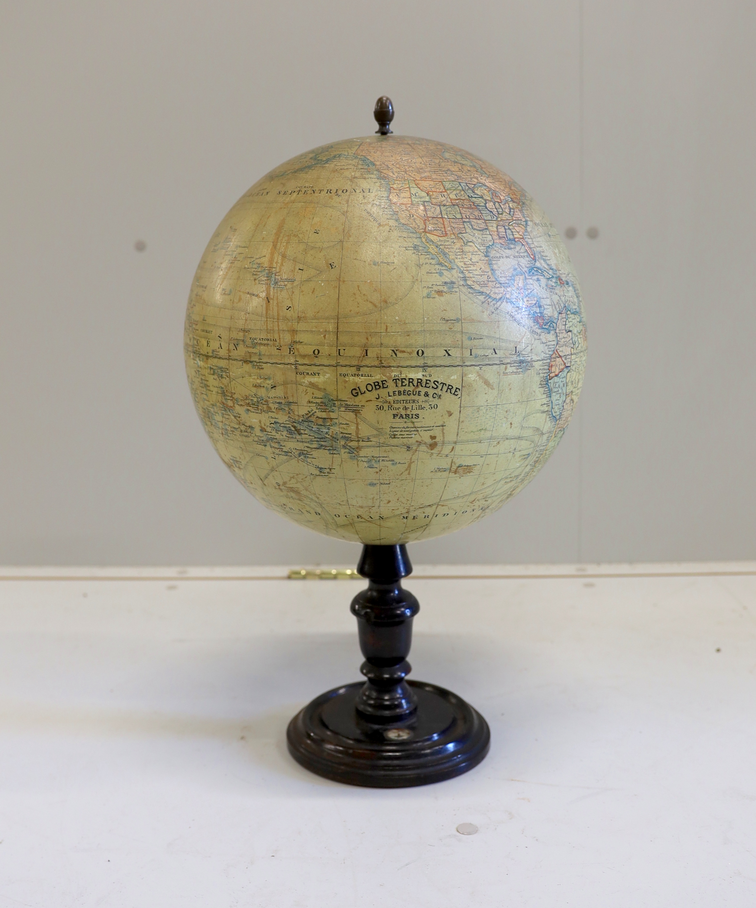 A 19th century 12 inch French globe, ‘Globe Terrestre’ published by J. Lebegue & Cie., Paris, on ebonised pine stand with inset compass, 53cm high on stand